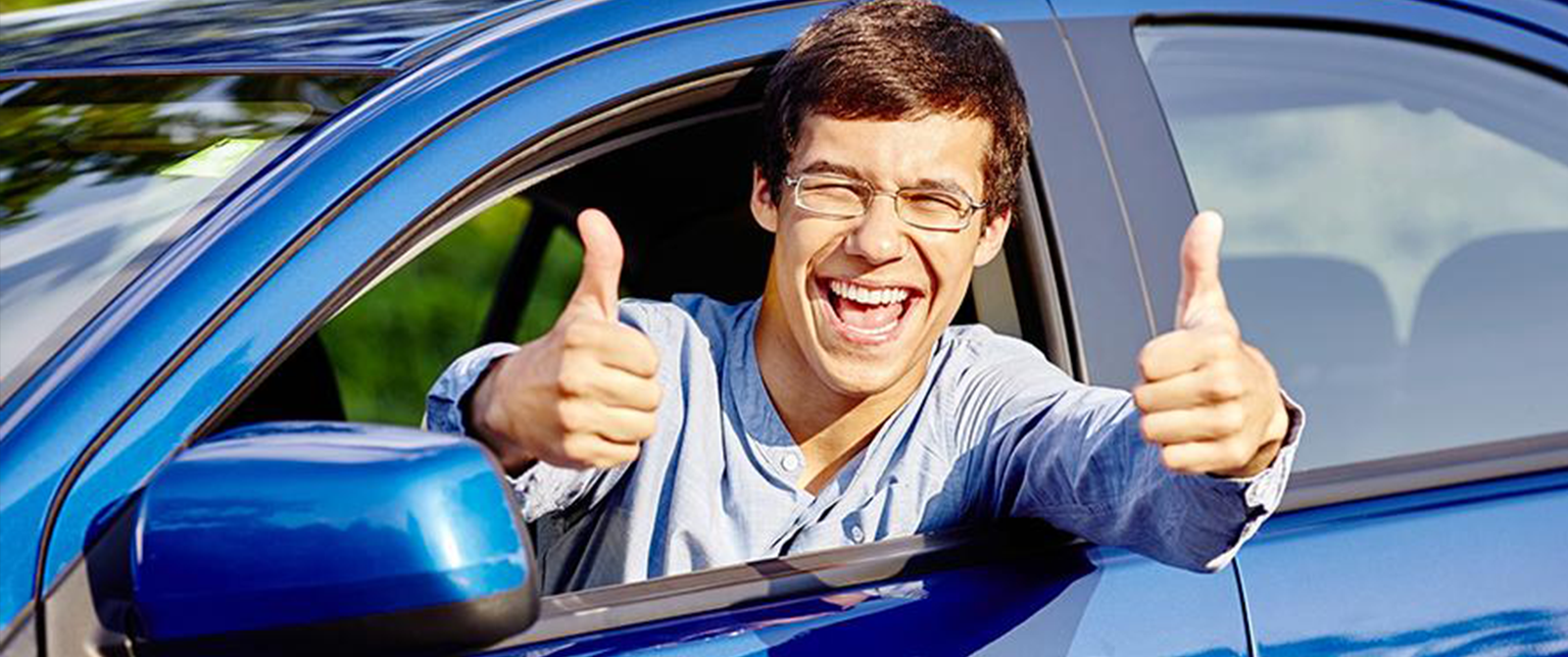 college driver with 2 thumbs up