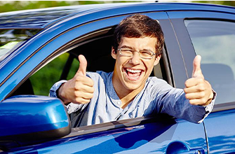 college driver with 2 thumbs up
