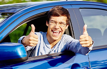 college driver with 2 thumbs up
