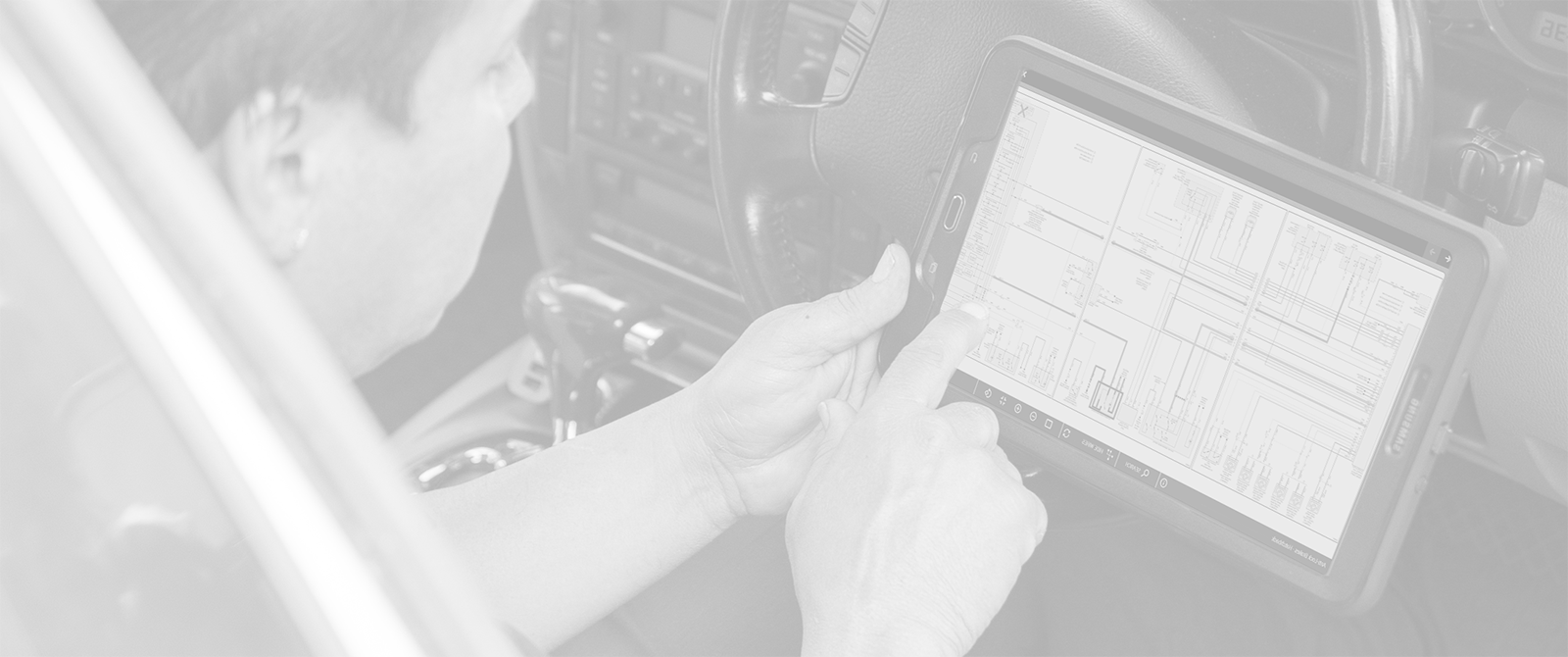 Technician looking at interactive color wiring diagrams on a tablet