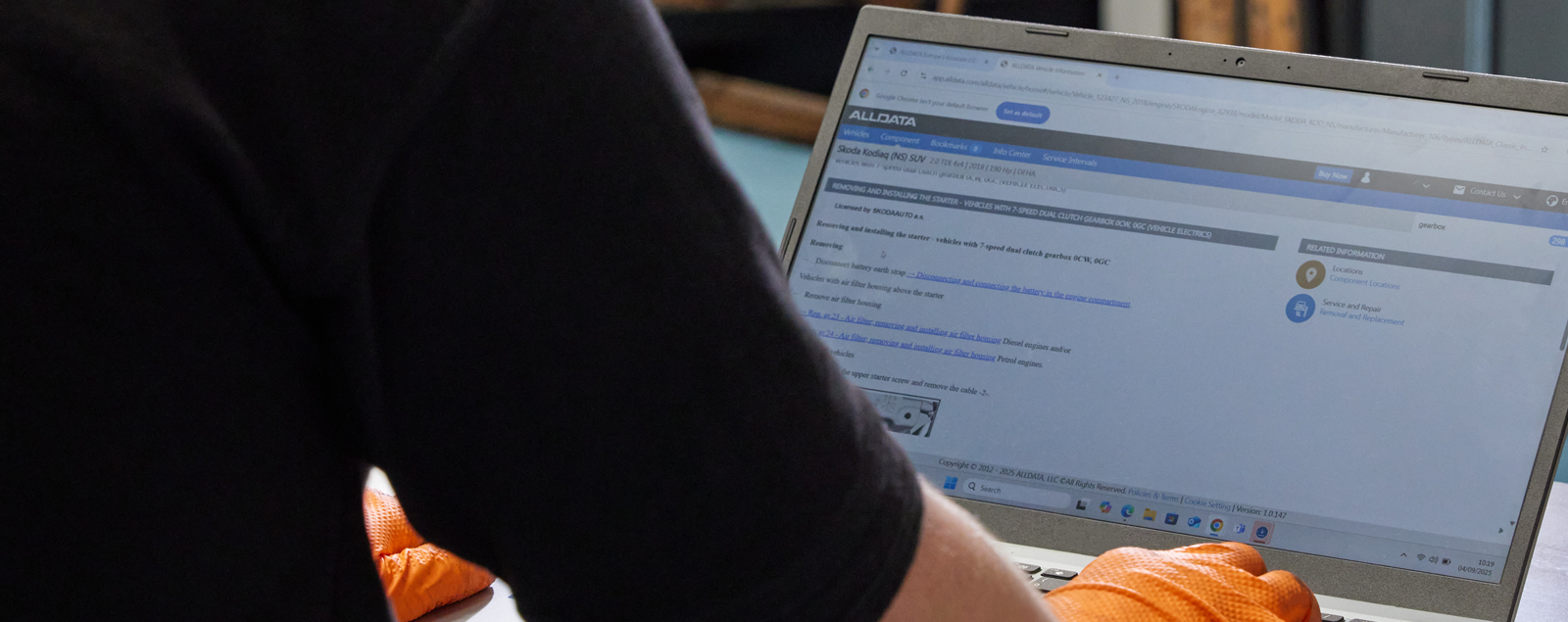 Technician working on ALLDATA on laptop