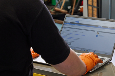 Technician working on ALLDATA on laptop