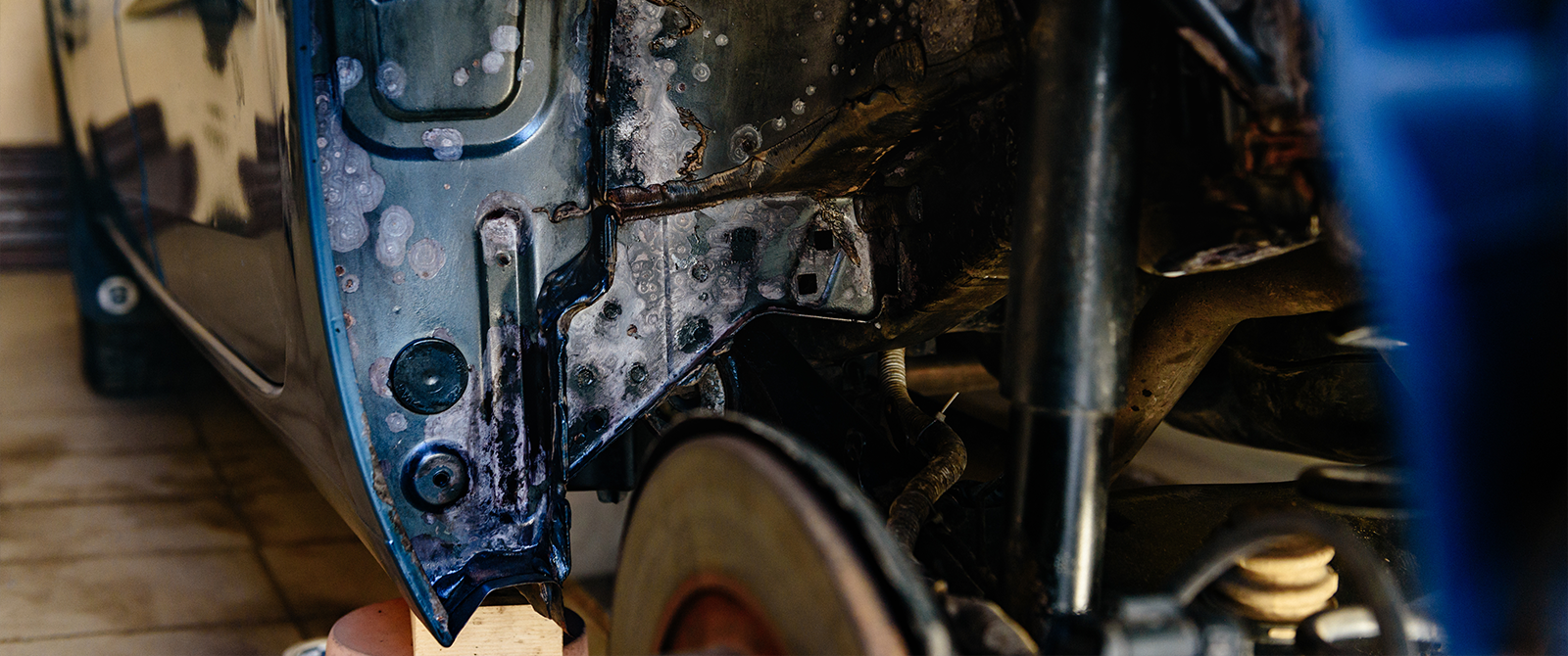 rust on the wheel well of a car