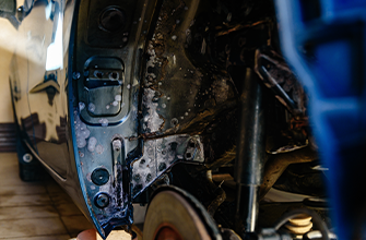 rust on the wheel well of a car