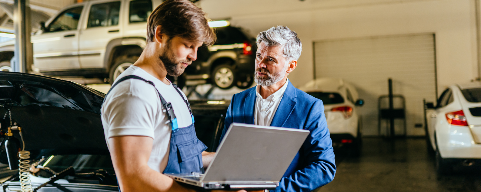 Business man and technician talking in workshop
