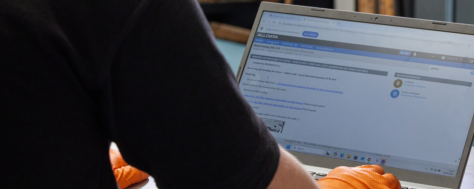 Technician working on ALLDATA on laptop