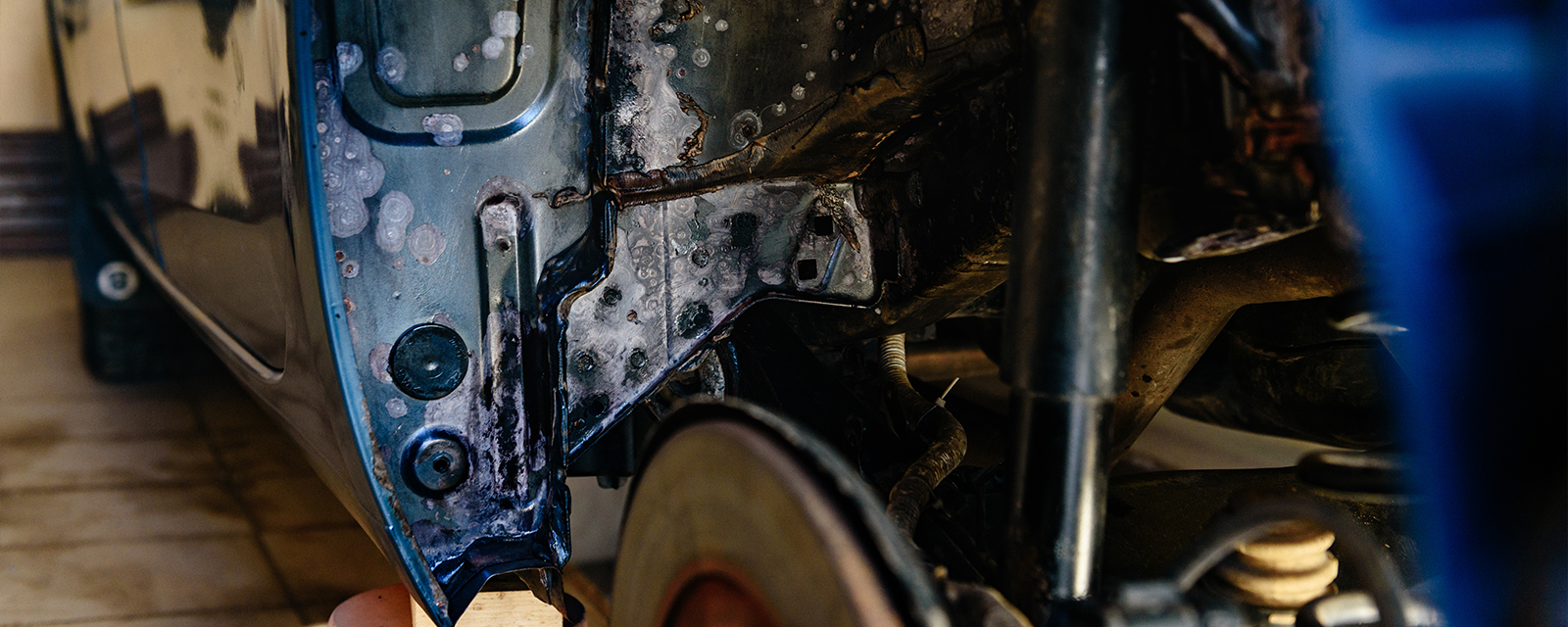 rust on the wheel well of a car