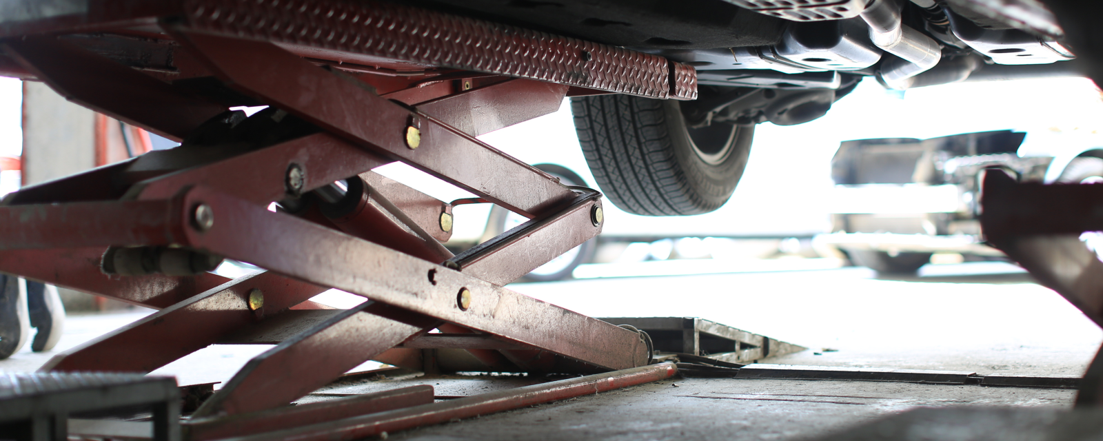 car on suspension rack in garage