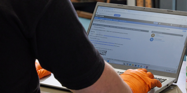 Technician working on ALLDATA on laptop