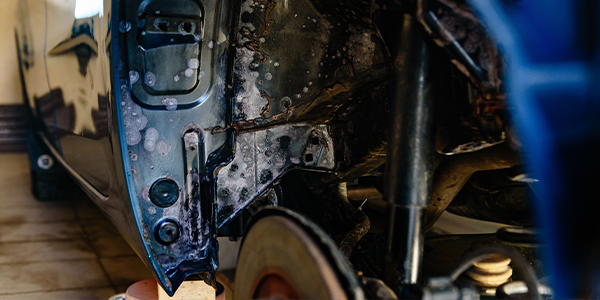 rust on the wheel well of a car