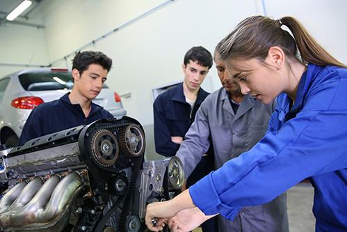 Group of mechanic students being trained on Engine