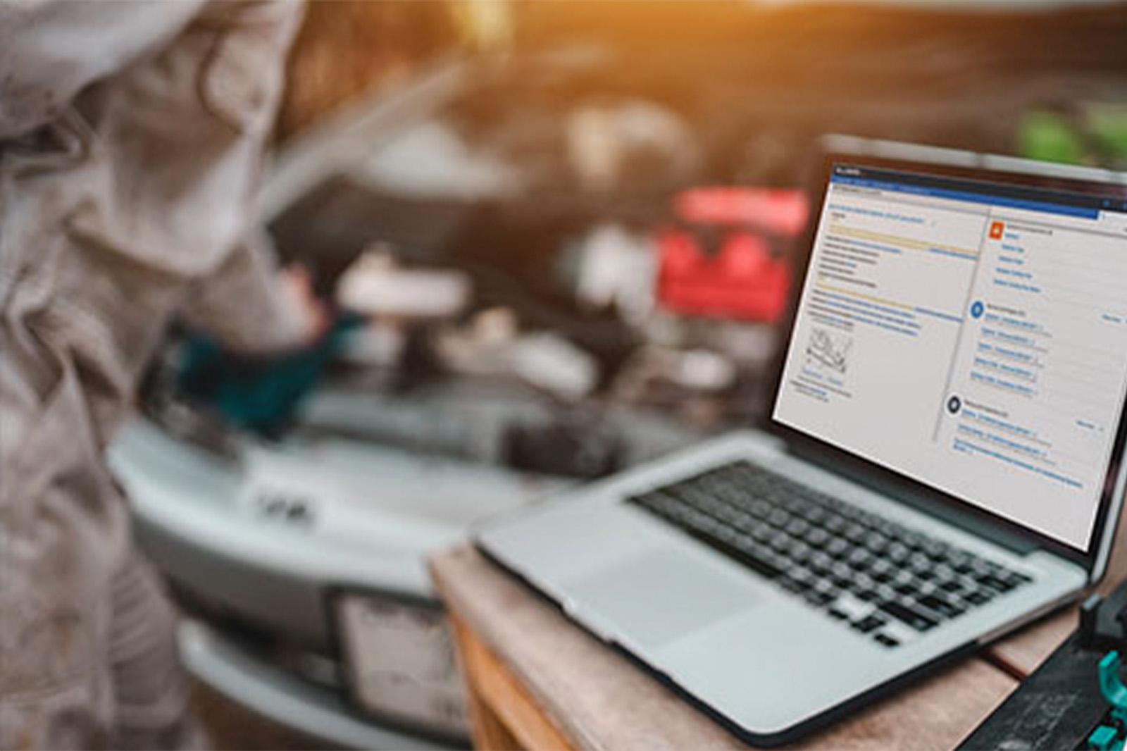 ALLDATAdiy by an open car hood