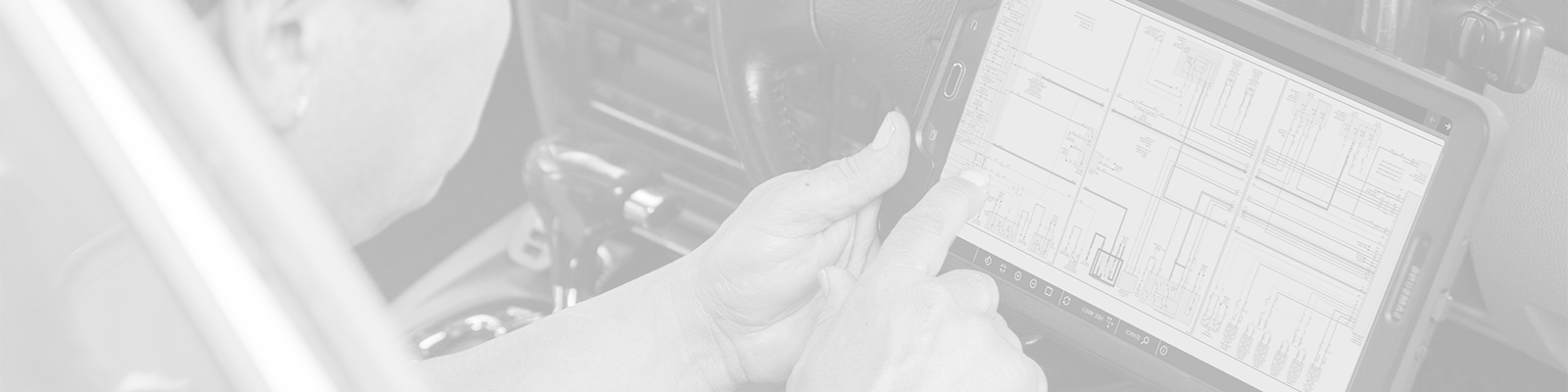 Technician looking at interactive color wiring diagrams on a tablet