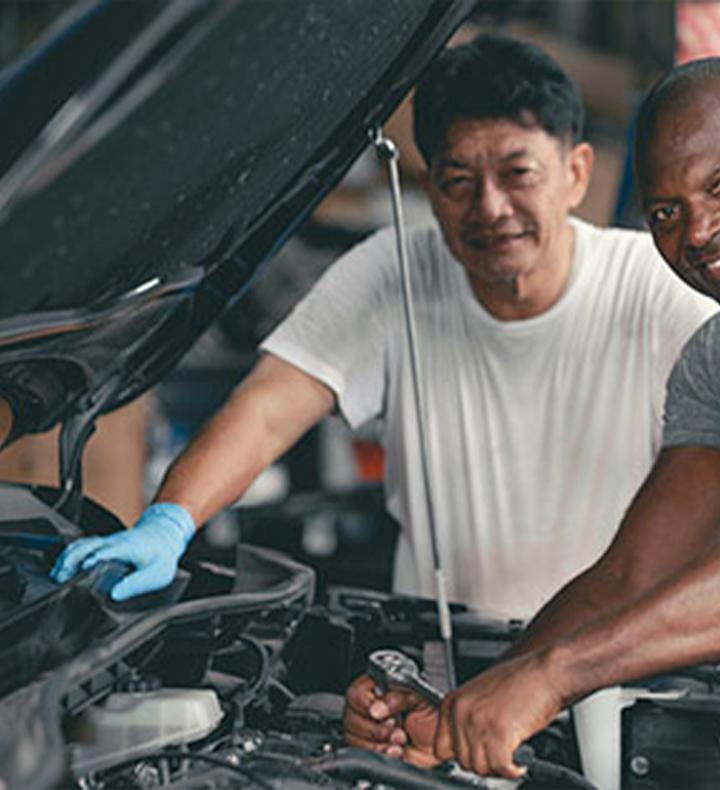 Dad and grad under a hood