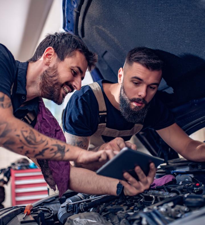 DIYers looking over a car engine