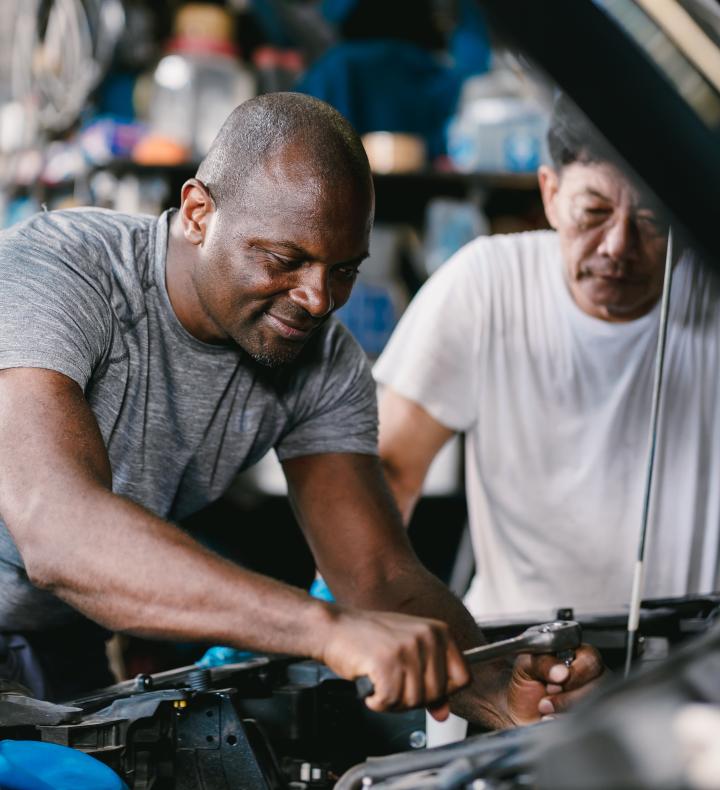 DIYers working on an engine