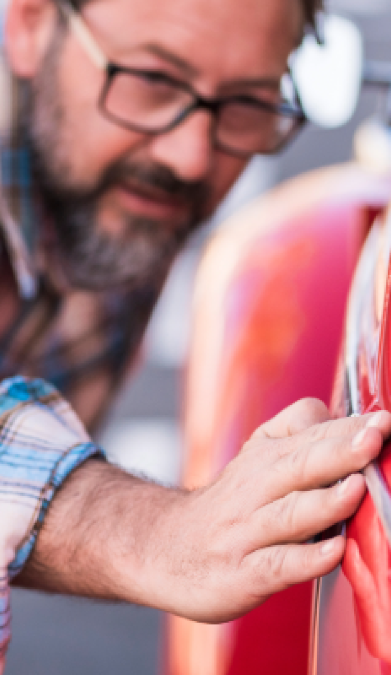 close man looking at his car